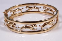 Lot 209 - A 9ct gold panther bangle, with single hinge...