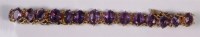 Lot 226 - An early 20th century gilt metal and amethyst...