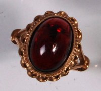 Lot 243 - A modern 9ct gold and garnet ladies dress ring,...