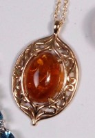 Lot 259 - A modern 9ct gold amber set pendant, the...