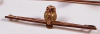 Lot 266 - A 9ct gold safety pin brooch, set with an owl,...