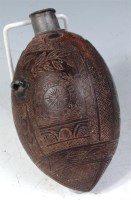 Lot 297 - A 19th century carved coconut shell powder...