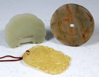 Lot 427 - A Chinese jade disc carving, with simplistic...