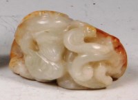 Lot 420 - A Chinese carved russet jade frog, upon a...