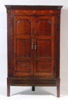Lot 564 - A George III oak corner cupboard, the...