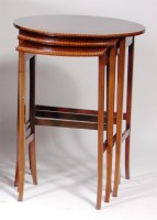 Lot 595 - An Edwardian walnut and inlaid oval nest of...