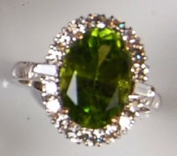Lot 221 - A contemporary 18ct white gold green peridot...