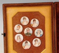 Lot 684 - A cased display of eight portrait miniatures,...