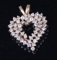 Lot 563 - An American 10ct gold diamond set ladies heart...