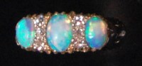 Lot 572 - An 18ct gold opal and diamond half hoop ladies...