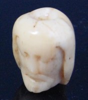 Lot 656 - A carved ivory double sided memento mori...
