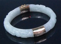 Lot 733 - A Chinese carved celadon jade gold mounted...