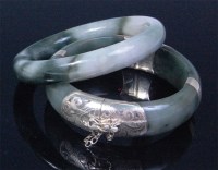 Lot 734 - Two modern Chinese jade bangles, to include;...
