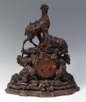 Lot 828 - A circa 1900 Black Forest carved wood mantel...