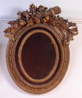 Lot 892 - A circa 1900 giltwood and gesso oval wall...