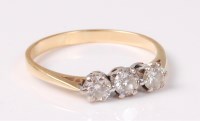 Lot 2523 - A three stone diamond ring, the three round...