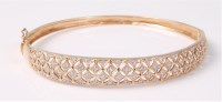 Lot 2552 - A 9ct diamond bangle, the tapering bangle,...