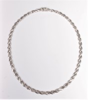 Lot 2579 - A 9ct white gold collarette, the shaped...