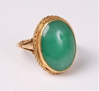Lot 2591 - A jade ring, the oval jade cabochon approx....