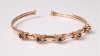 Lot 2603 - A blue and white hardstone cluster bangle, the...