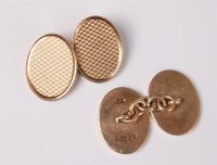 Lot 2613 - A pair of 9ct cufflinks, the oval engine...