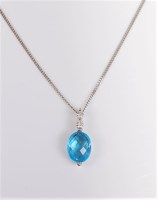Lot 2688 - A 9ct white gold topaz and diamond pendant...