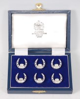 Lot 1511 - A set of six silver menu holders, each in the...