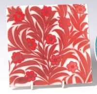 Lot 35 - An Arts & Crafts ruby lustre decorated pottery...