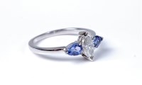 Lot 2129 - A 14ct three stone tanzanite and diamond ring,...