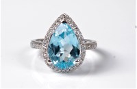 Lot 2146 - A topaz and diamond ring, the pear shaped...