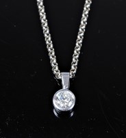 Lot 2173 - An 18ct solitaire pendant, the round brilliant...