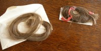 Lot 2251 - An envelope containing two locks of hair of...