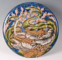 Lot 194 - A Cobridge stoneware charger decorated with...