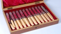 Lot 1104 - An Edwardian oak canteen containing twelve...