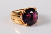 Lot 1135 - An amethyst dress ring, the round amethyst,...