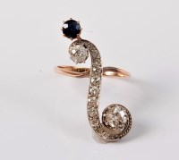 Lot 1151 - A sapphire and diamond 'upfinger' ring, the...