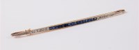 Lot 1157 - A sapphire and diamond bar brooch, the long...