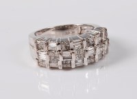 Lot 1199 - A diamond dress ring, the three stepped rows,...