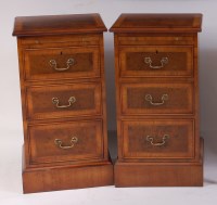 Lot 1511 - A pair of walnut three drawer bedside chests,...