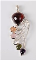 Lot 2673 - A multi gemset silver pendant, the pear shaped...