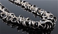 Lot 2572 - A black onyx and silver necklace, the...