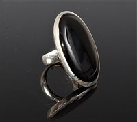 Lot 2574 - A black onyx ring, the large oval black onyx...