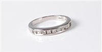 Lot 2579 - An 18ct diamond half hoop eternity ring, the...