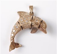 Lot 2591 - A dolphin pendant, the four piece articulated...