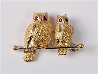 Lot 2197 - An 18ct owl brooch, the two naturalistically...