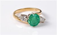 Lot 2216 - An 18ct emerald and diamond ring, the round...