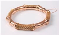 Lot 2280 - A 9ct faux bamboo bangle, the hinged faux...