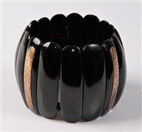 Lot 2335 - A jet bracelet, the slightly domed elongated...