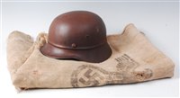 Lot 83 - A WW II German beaded pattern steel helmet,...