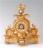 Lot 2606 - A Victorian gilt metal mantel clock under...